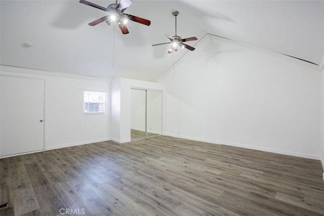 additional living space with ceiling fan, high vaulted ceiling, and dark wood-type flooring