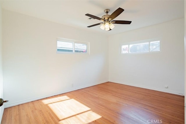 spare room featuring hardwood / wood-style flooring and ceiling fan