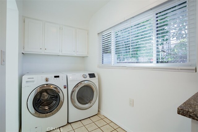 washroom with cabinets, independent washer and dryer, and light tile patterned floors