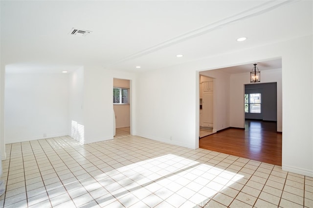 spare room featuring light tile patterned floors