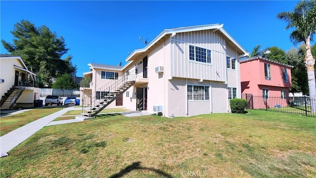 rear view of house featuring a lawn