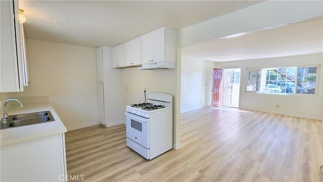 2325 Angela St, Pomona, CA 91766 - kitchen featuring white range with gas stovetop, light hardwood / wood-style floors, white cabinetry, and sink