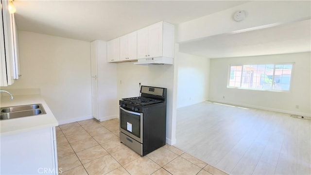 2325 Angela St, Pomona, CA 91766 - kitchen with white cabinets, stainless steel gas stove, light hardwood / wood-style floors, and sink