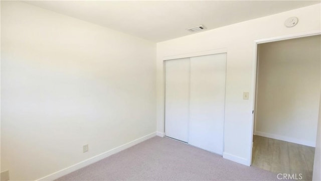 2325 Angela St, Pomona, CA 91766 - unfurnished bedroom with light colored carpet and a closet