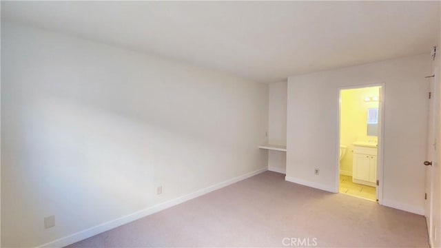 2325 Angela St, Pomona, CA 91766 - unfurnished bedroom with ensuite bathroom and light colored carpet