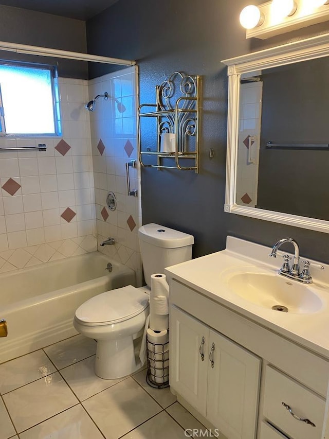 full bathroom featuring tile patterned flooring, vanity, tiled shower / bath combo, and toilet