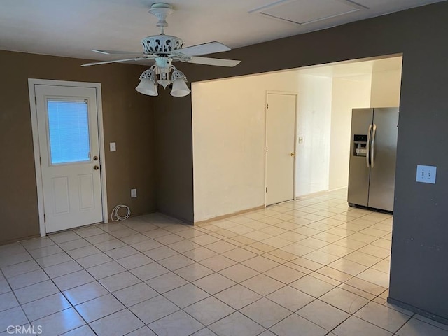 tiled empty room with ceiling fan