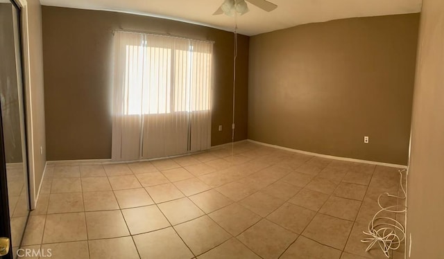 spare room featuring light tile patterned floors and ceiling fan