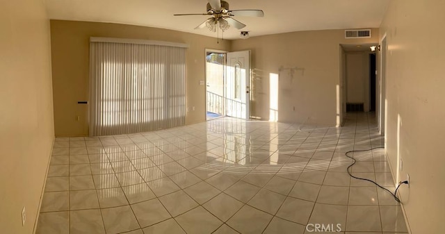 tiled empty room with ceiling fan