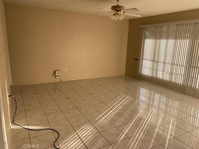 empty room featuring ceiling fan and light tile patterned floors