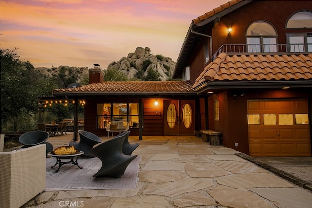 view of front of home with a patio and a garage