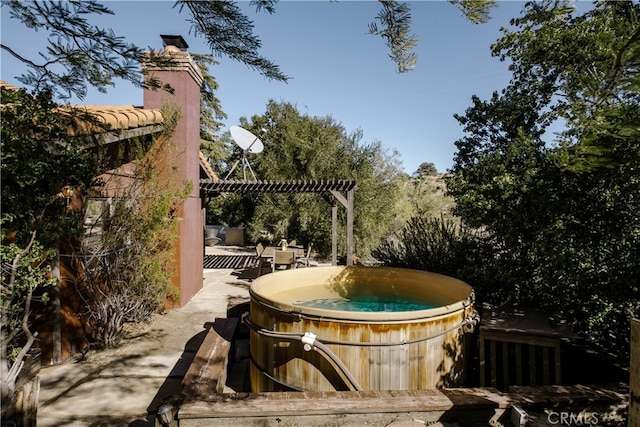 view of home's community featuring a pergola and a hot tub