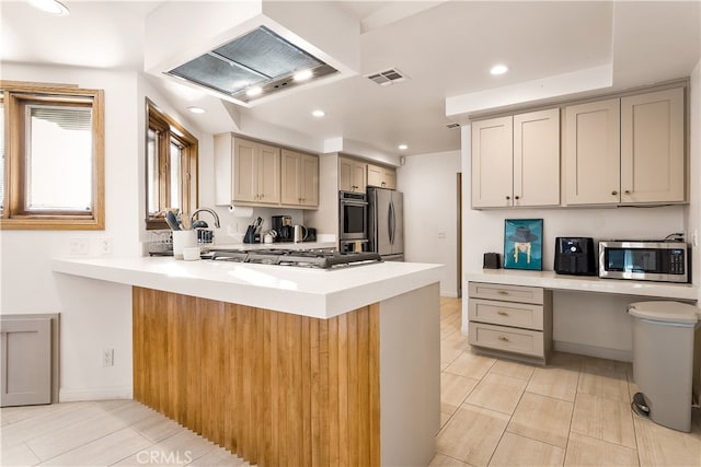 kitchen featuring ventilation hood, kitchen peninsula, a kitchen breakfast bar, and stainless steel appliances