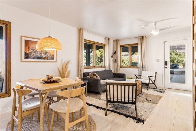 tiled dining space with ceiling fan