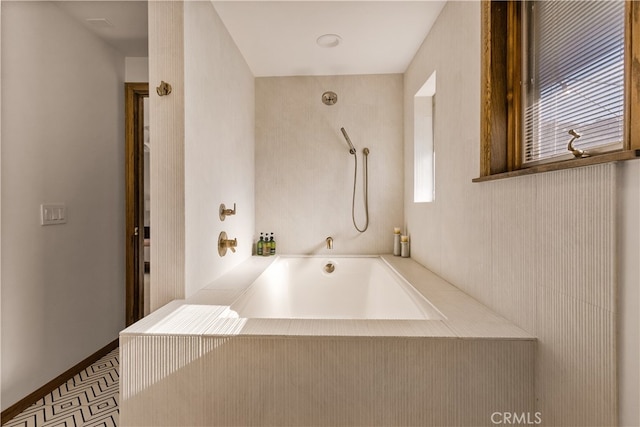 bathroom featuring a healthy amount of sunlight and a tub