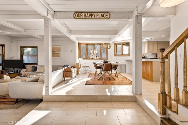 tiled foyer featuring beam ceiling