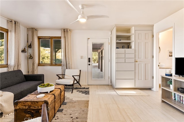 living room with a wealth of natural light and ceiling fan