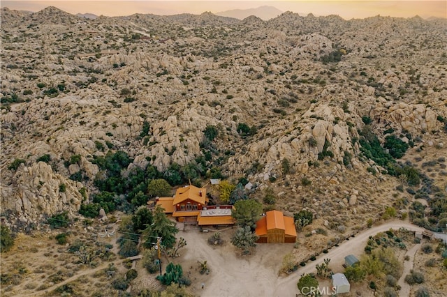 aerial view at dusk featuring a mountain view