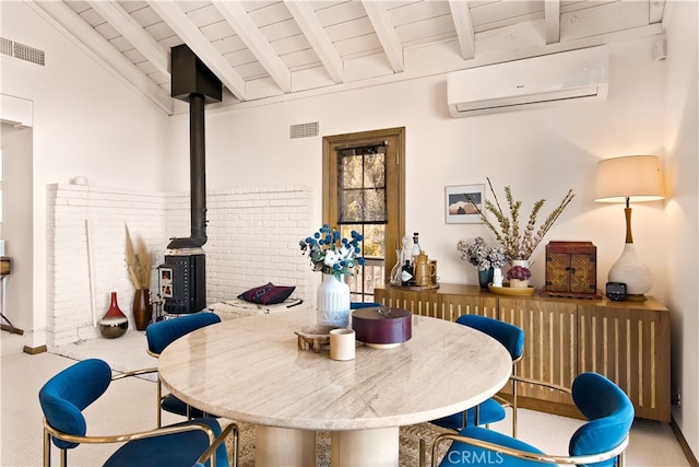 dining room with vaulted ceiling with beams, carpet flooring, a wood stove, and an AC wall unit