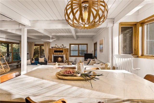 dining space with wood ceiling and beamed ceiling