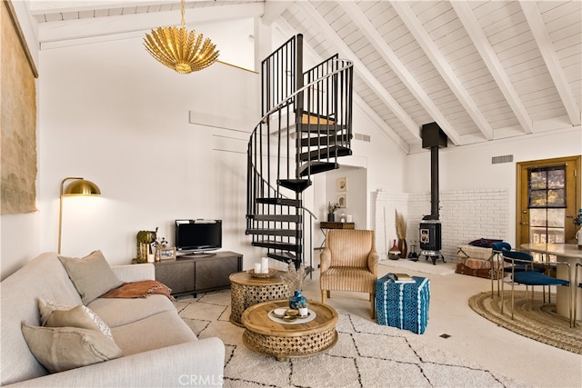 living room featuring light colored carpet, beamed ceiling, a wood stove, and high vaulted ceiling