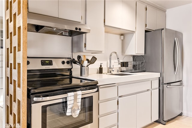 kitchen featuring backsplash, white cabinetry, appliances with stainless steel finishes, and sink