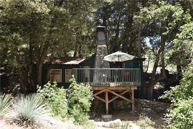 back of property with a wooden deck