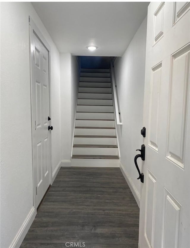 stairs featuring hardwood / wood-style floors