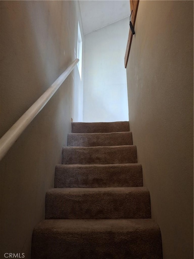 stairway with lofted ceiling