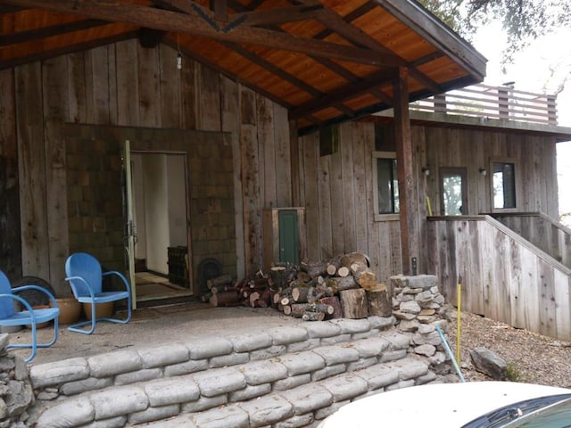 misc room featuring beam ceiling, wood walls, high vaulted ceiling, and wood ceiling