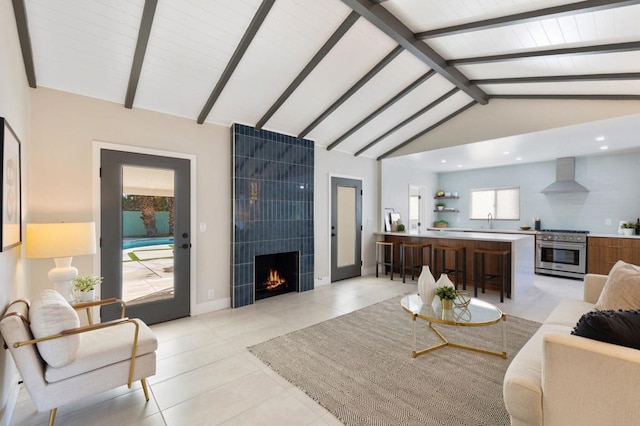 tiled living room with vaulted ceiling with beams and a fireplace