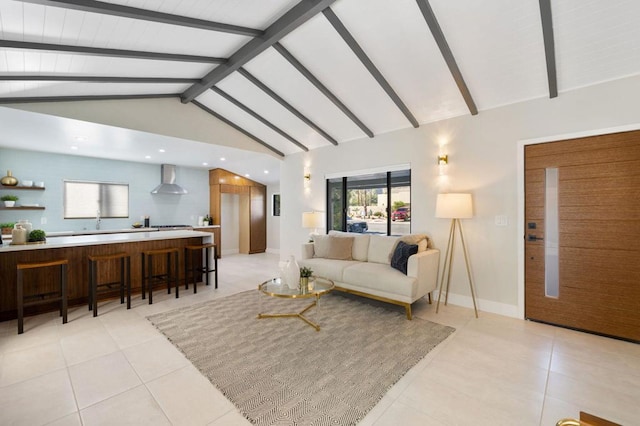 living room featuring lofted ceiling with beams and light tile patterned floors