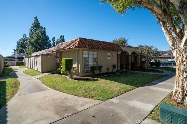 mediterranean / spanish house with a front lawn