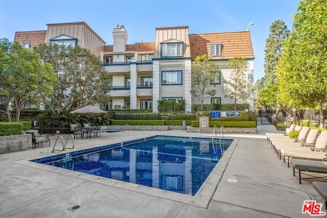 view of swimming pool with a patio area