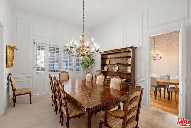 carpeted dining room with a chandelier and crown molding