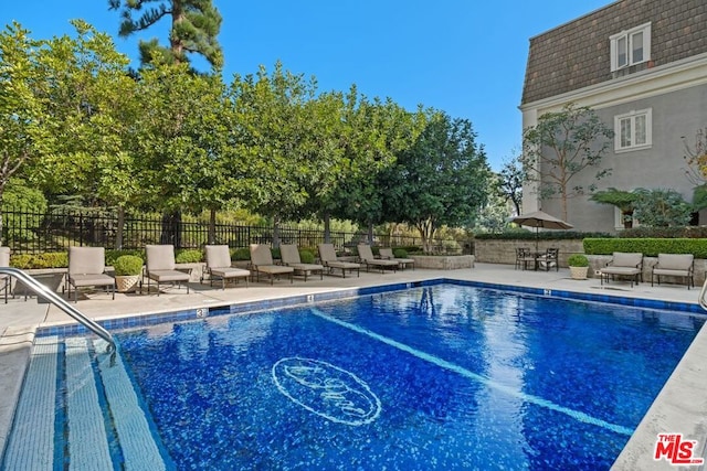 view of swimming pool with a patio