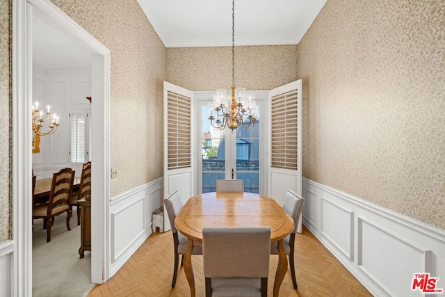 dining area featuring an inviting chandelier, crown molding, and light parquet flooring