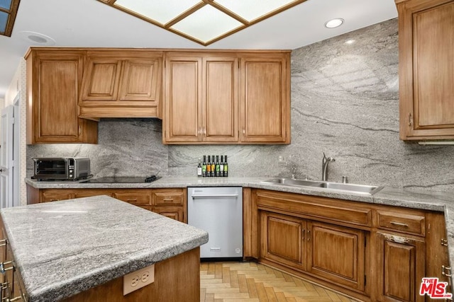 kitchen with backsplash, sink, light parquet flooring, and stainless steel dishwasher