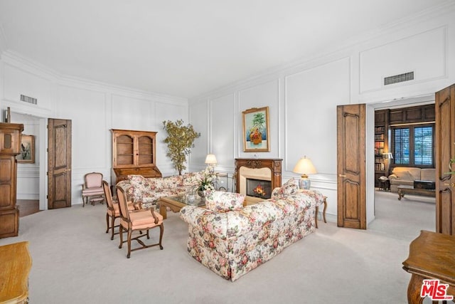 living room featuring ornamental molding and light carpet