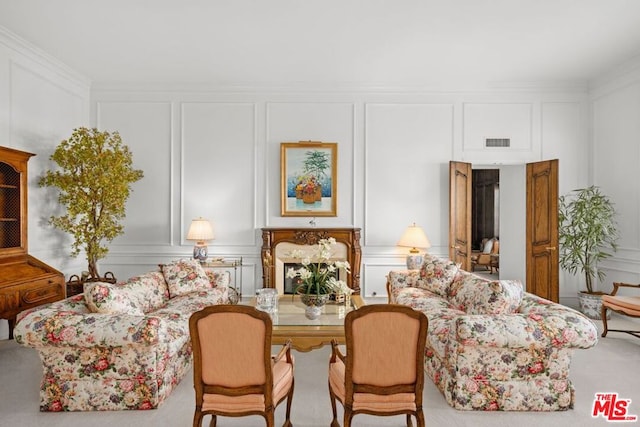 carpeted living room featuring ornamental molding