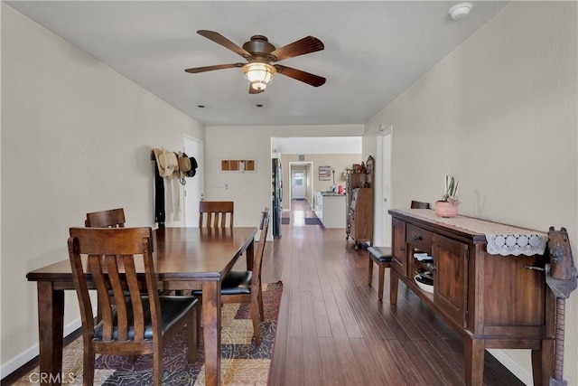 dining area featuring ceiling fan and dark hardwood / wood-style flooring