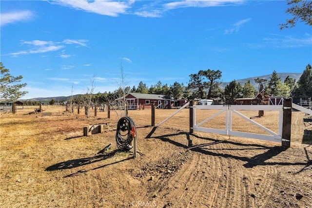 view of gate featuring a mountain view and a rural view