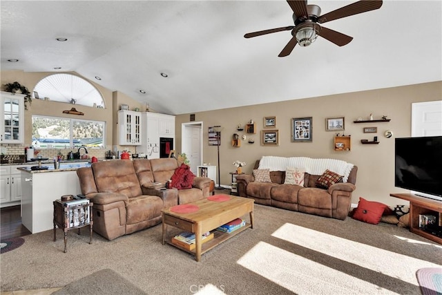 carpeted living room featuring vaulted ceiling and ceiling fan