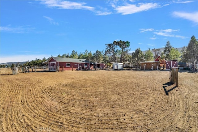 view of yard with a rural view and an outbuilding