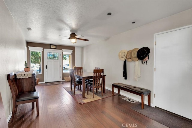 dining area with a textured ceiling, dark hardwood / wood-style floors, and ceiling fan