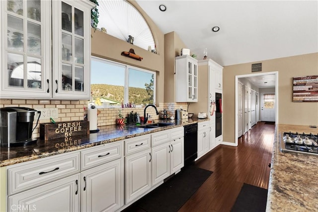 kitchen featuring white cabinets, dishwasher, and sink