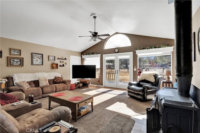 living room featuring ceiling fan, light tile patterned floors, high vaulted ceiling, and french doors