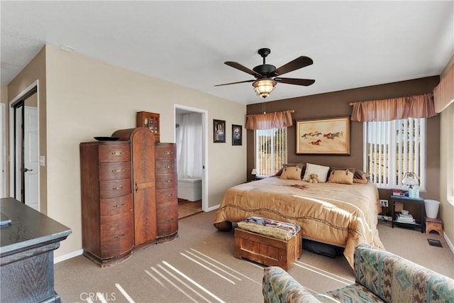 bedroom with ceiling fan, carpet floors, and multiple windows