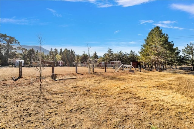 view of yard with a mountain view and a rural view