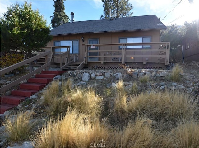 back of property featuring a wooden deck